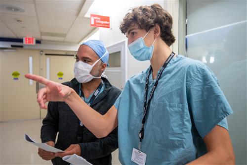 student intern with doctor pointing